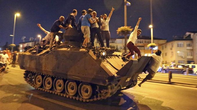 Protesters climb onto a tank in Istanbul.TOLGA BOZOGLU/EPA